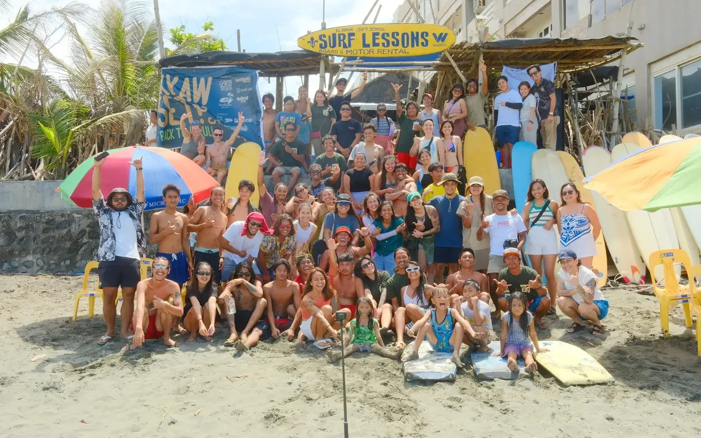 The El Dawn crew, students and friends together under the Surf Lessons sign on Sabang Beach